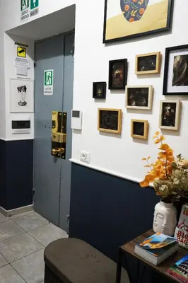 a room with a wall with pictures on it at Stay Smart Termini Esquilino in Rome
