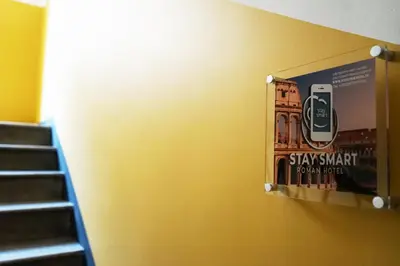 a poster of a cell phone hanging on a wall at Stay Smart Termini Esquilino in Rome