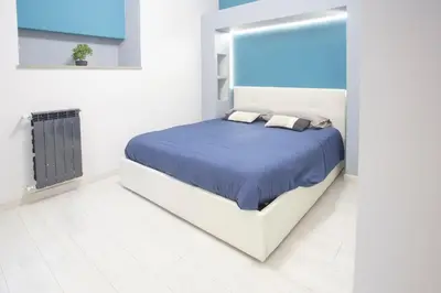 a bedroom with a bed and two chairs at Lounge House Vatican - San Pietro in Rome