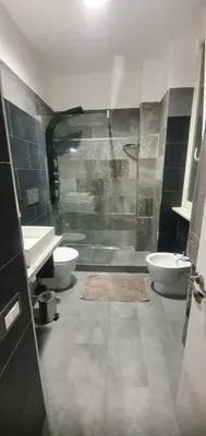 a bathroom with a sink and a glass shower at Lounge House Vatican - San Pietro in Rome