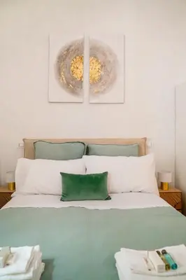 a bedroom with a bed with two pictures on the wall at Sette Chiese Apartment in Rome