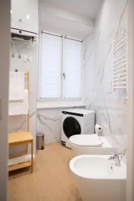 a bathroom with a toilet and a microwave at Sette Chiese Apartment in Rome