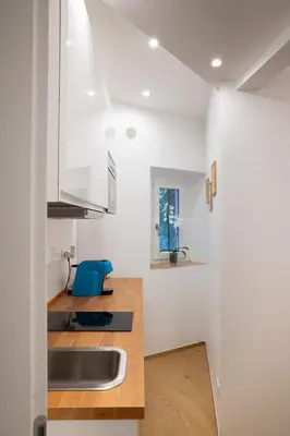 a kitchen with white walls and a sink at Sette Chiese Apartment in Rome