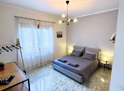 a bedroom with a bed and a table and a window at Casa vacanze Roma Adelaide's house in Rome