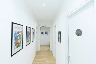 a hallway with framed art on the walls at Grace's house Roma Trastevere in Rome