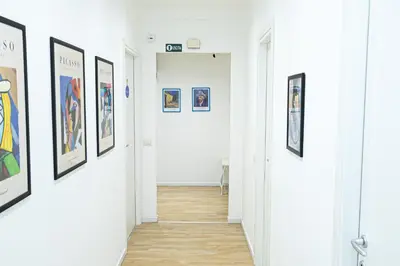 a hallway with framed art on the walls at Grace's house Roma Trastevere in Rome