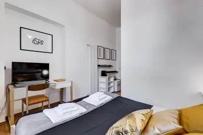 a bedroom with a couch and a desk with a computer at BDC - Majestic 4-Bdr in Termini in Rome