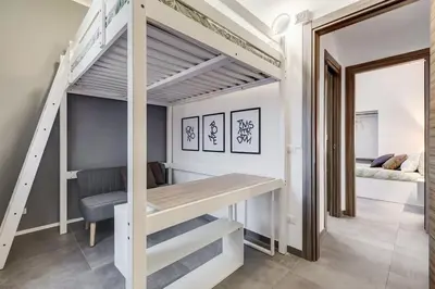a loft bed with a desk in a room at BDC - Majestic 4-Bdr in Termini in Rome