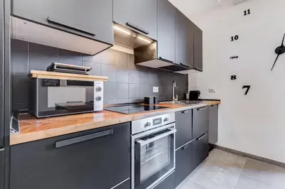 a kitchen with stainless steel appliances and wooden counter tops at BDC - Majestic 4-Bdr in Termini in Rome