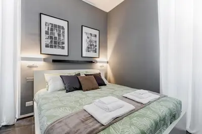 a bedroom with a bed with two towels on it at BDC - Majestic 4-Bdr in Termini in Rome