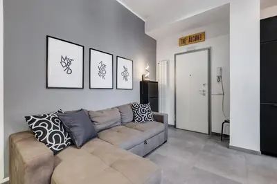 a living room with a couch and some pictures on the wall at BDC - Majestic 4-Bdr in Termini in Rome