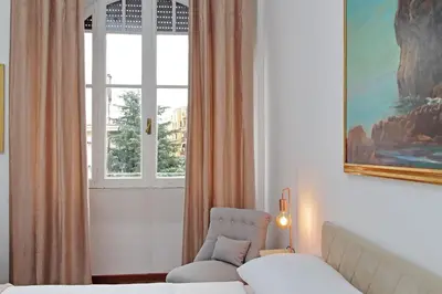 a room with a bed and a chair and a window at 4BNB - Giant Giuliana Vatican Museum in Rome