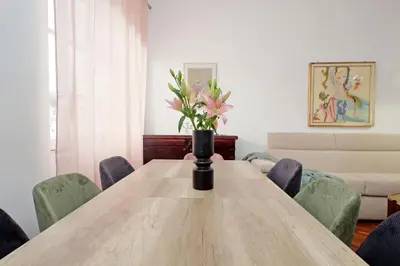 a vase of flowers sitting on a wooden table at 4BNB - Giant Giuliana Vatican Museum in Rome