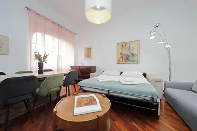 a room with a bed and a table and chairs at 4BNB - Giant Giuliana Vatican Museum in Rome