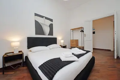a bedroom with a large white bed with towels on it at 4BNB - Giant Giuliana Vatican Museum in Rome