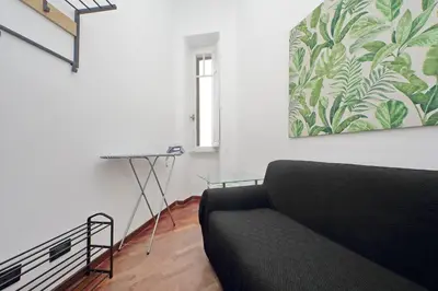 a living room with a couch and a painting on the wall at 4BNB - Giant Giuliana Vatican Museum in Rome