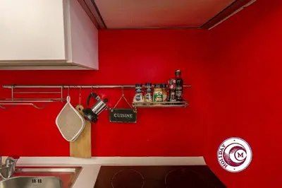 a red kitchen with a sink and a red wall at La Torre Della Scimmia nido romantico a Piazza Navona in Rome