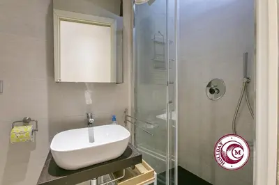 a bathroom with a sink and a glass shower at La Torre Della Scimmia nido romantico a Piazza Navona in Rome