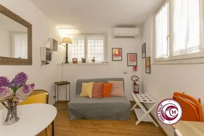 a living room with a couch and a table at La Torre Della Scimmia nido romantico a Piazza Navona in Rome