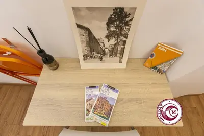 a table with two books and a cup of coffee at La Torre Della Scimmia nido romantico a Piazza Navona in Rome