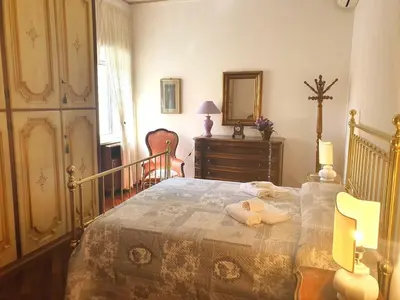 a bedroom with a bed and a dresser and a mirror at Holiday apartment in Rome in Rome