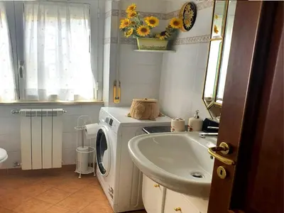 a bathroom with a washing machine and a sink at Holiday apartment in Rome in Rome