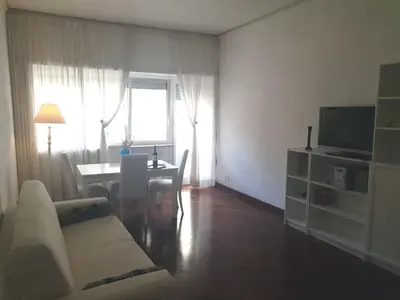 a living room with a couch and a table at Holiday apartment in Rome in Rome