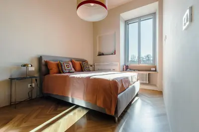 a bedroom with a bed and a large window at Roman Retreat En-suite Room in Rome