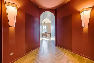 a hallway with red walls and wood floors at Roman Retreat En-suite Room in Rome
