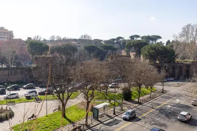 a city with cars parked in a parking lot at Roman Retreat En-suite Room in Rome