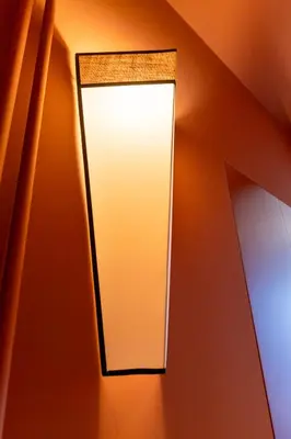 a light fixture on a wall in a room at Roman Retreat En-suite Room in Rome