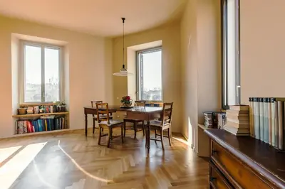 a dining room with a table and chairs at Roman Retreat En-suite Room in Rome