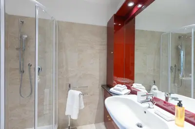 a bathroom with a sink and a glass shower at Amazing Via del Tritone in Rome
