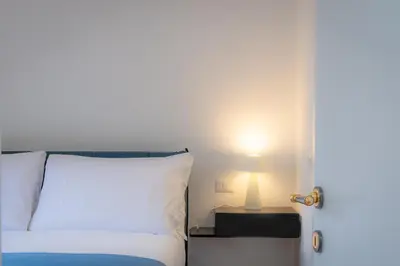 a bedroom with a bed and a lamp on a table at Amazing Via del Tritone in Rome