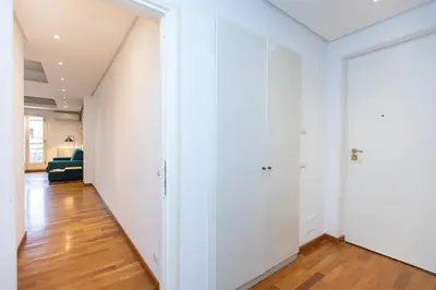 an empty hallway with white walls and wood floors at Amazing Via del Tritone in Rome
