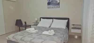 a bedroom with a bed with towels on it at Casa Nuccia,Close to Vatican city and Gemelli in Rome