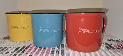 three colorful cups sitting on top of a table at Casa Nuccia,Close to Vatican city and Gemelli in Rome