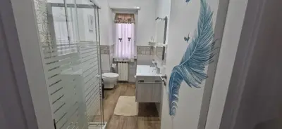 a bathroom with a blue dolphin painted on the wall at Casa Nuccia,Close to Vatican city and Gemelli in Rome