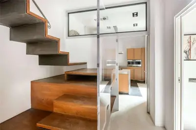 a staircase in a house with a glass wall at Luce Trastevere Retreat by Romeloft in Rome