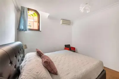 a small bedroom with a bed and a window at Luce Trastevere Retreat by Romeloft in Rome