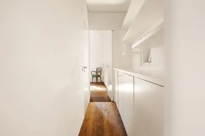 a hallway with white walls and a wooden floor at Luce Trastevere Retreat by Romeloft in Rome