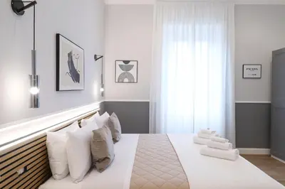 a bedroom with a large bed with white pillows at St Peter & Vatican Luxury Suites - Boutique Suites in Rome Centre & Vatican - AC, Wifi & Metro 5 min in Rome
