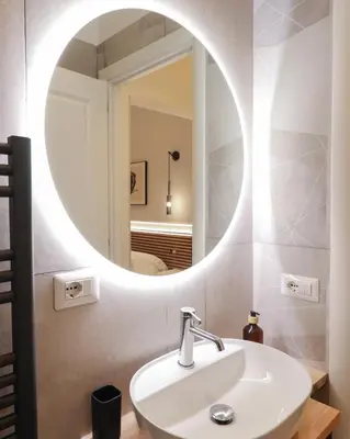 a bathroom with a white sink and a mirror at St Peter & Vatican Luxury Suites - Boutique Suites in Rome Centre & Vatican - AC, Wifi & Metro 5 min in Rome