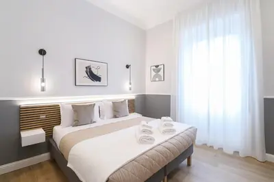 a bedroom with a large bed with towels on it at St Peter & Vatican Luxury Suites - Boutique Suites in Rome Centre & Vatican - AC, Wifi & Metro 5 min in Rome