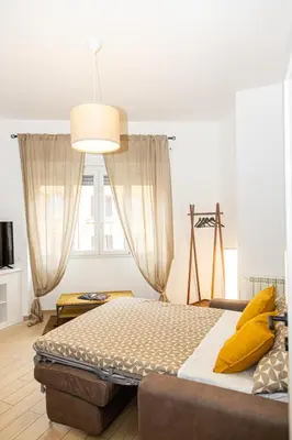 a bedroom with a large bed with yellow pillows at La Casa di Chicca - Musei Vaticani in Rome