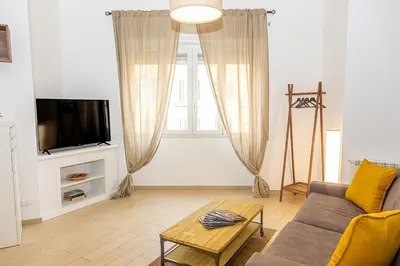 a living room with a couch and a tv at La Casa di Chicca - Musei Vaticani in Rome