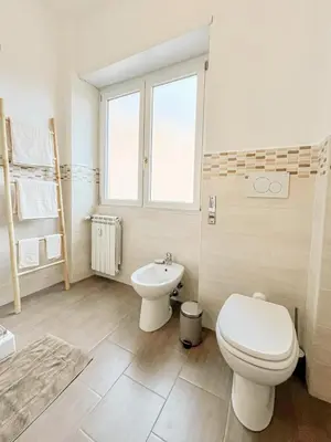a bathroom with a toilet and a sink at La Casa di Chicca - Musei Vaticani in Rome