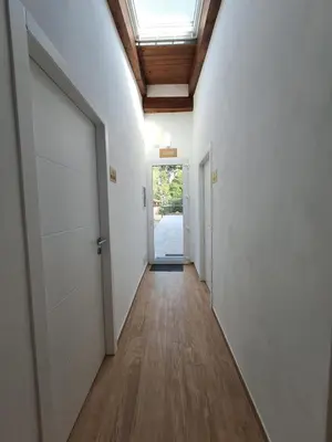 a hallway with white walls and a skylight at Luxury AmazingAppiaAntica-Quirinale in Rome