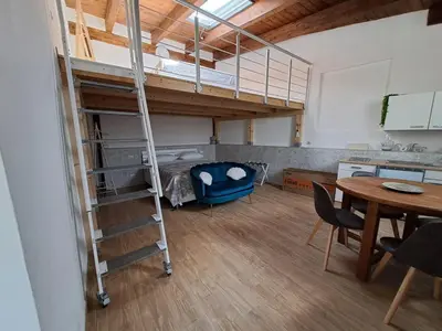 a room with a bunk bed and a dining room at Luxury AmazingAppiaAntica-Quirinale in Rome