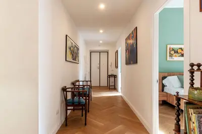 a hallway with a room with a bed and chairs at La casa di Oreste al Vaticano in Rome